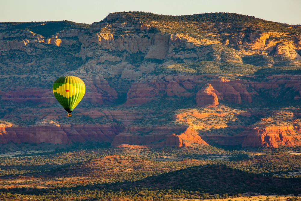 A,Green,Hot,Air,Balloon,Flying,Over,The,Red,Rock